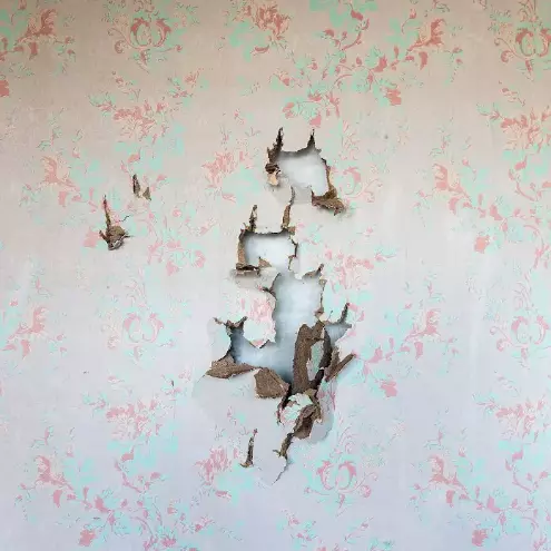 wallpaper damaged and torn from drywall