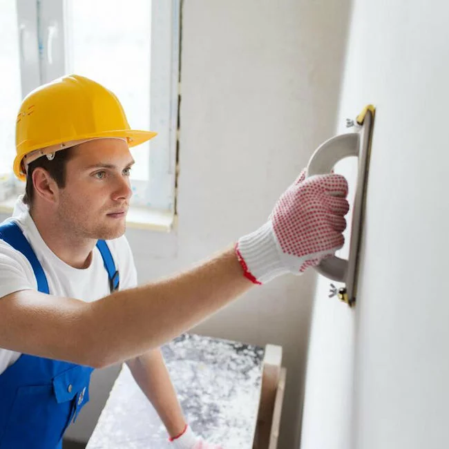 Man applying skim coat to drywall